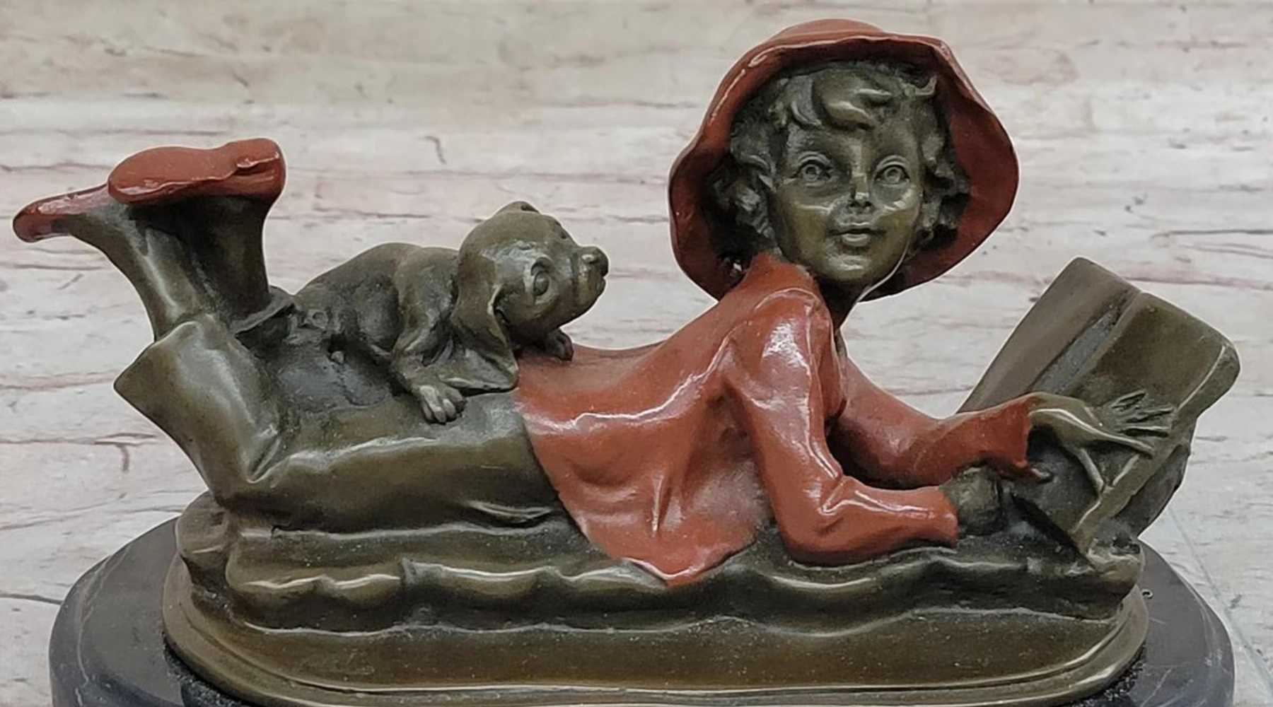 Girl reading book bronze sculpture with dog in relaxed pose