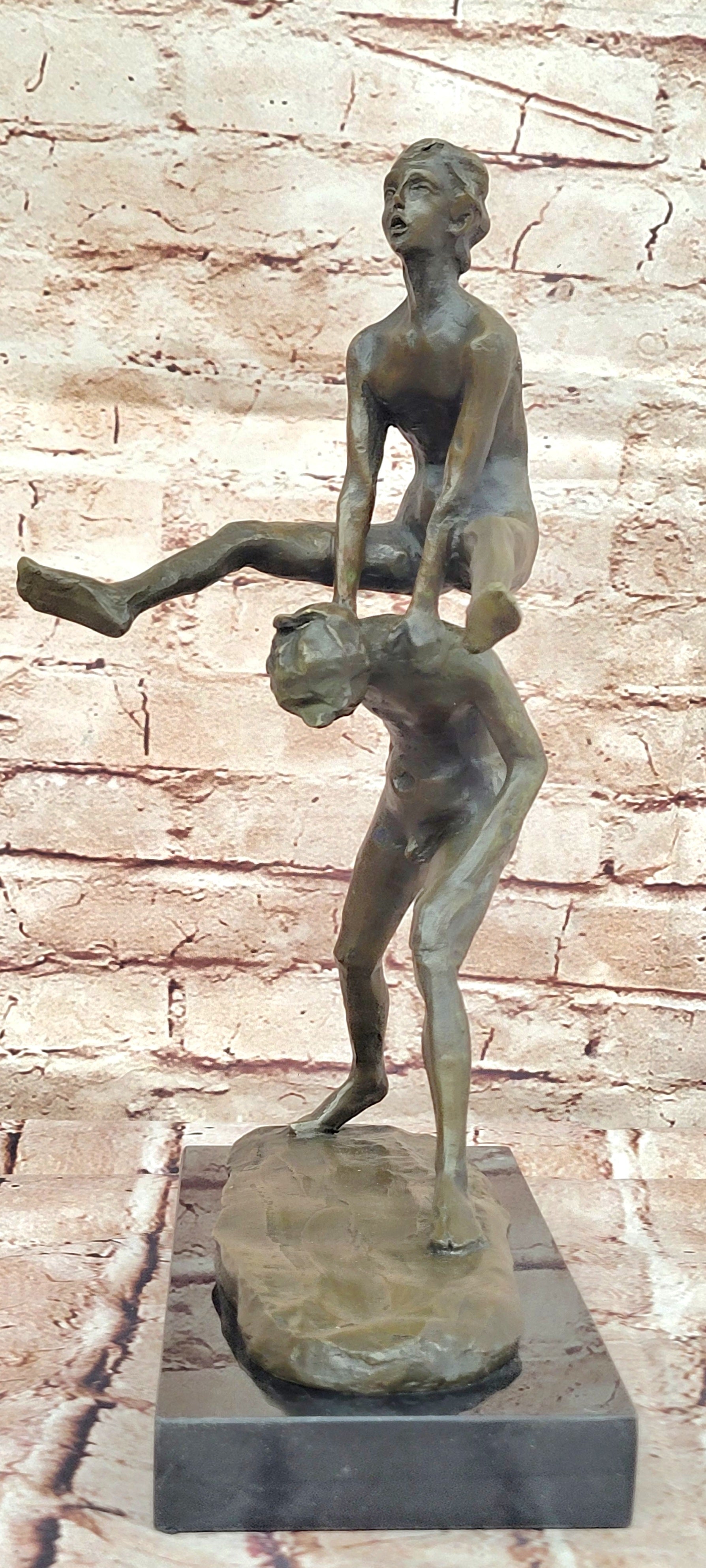 A bronze sculpture depicting two children playing leap-frog Home Decor Sale