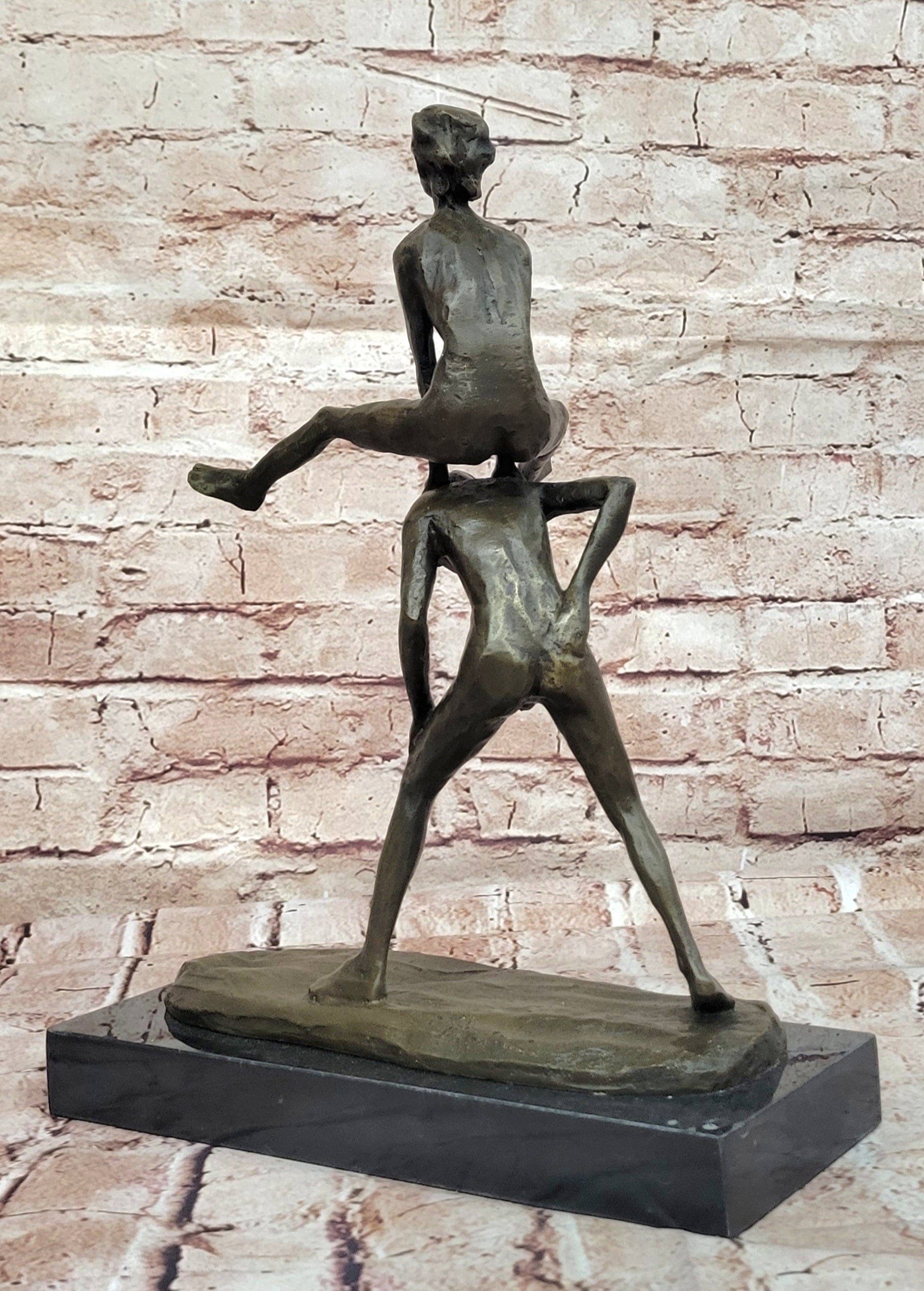 A bronze sculpture depicting two children playing leap-frog Home Decor Sale