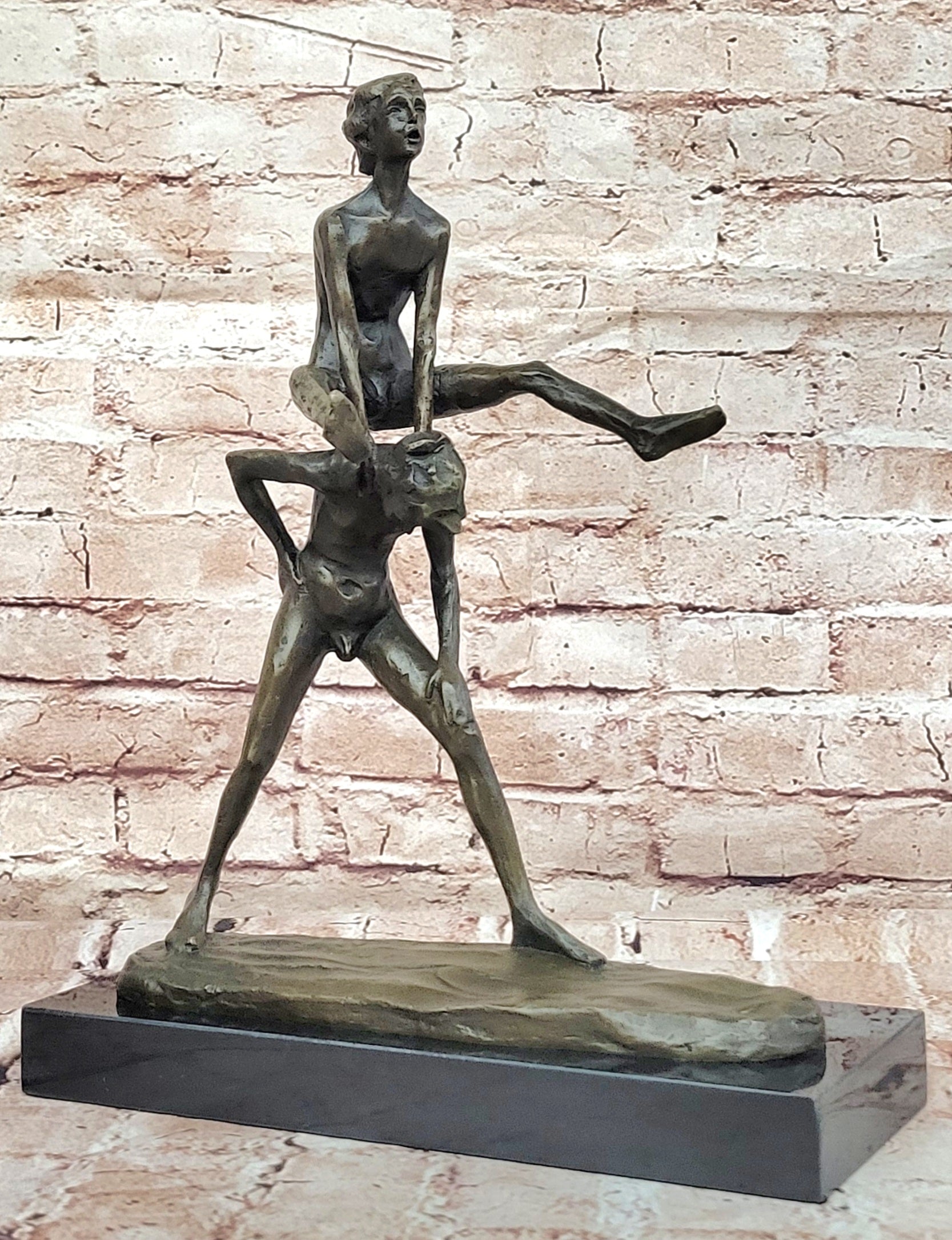 A bronze sculpture depicting two children playing leap-frog Home Decor Sale