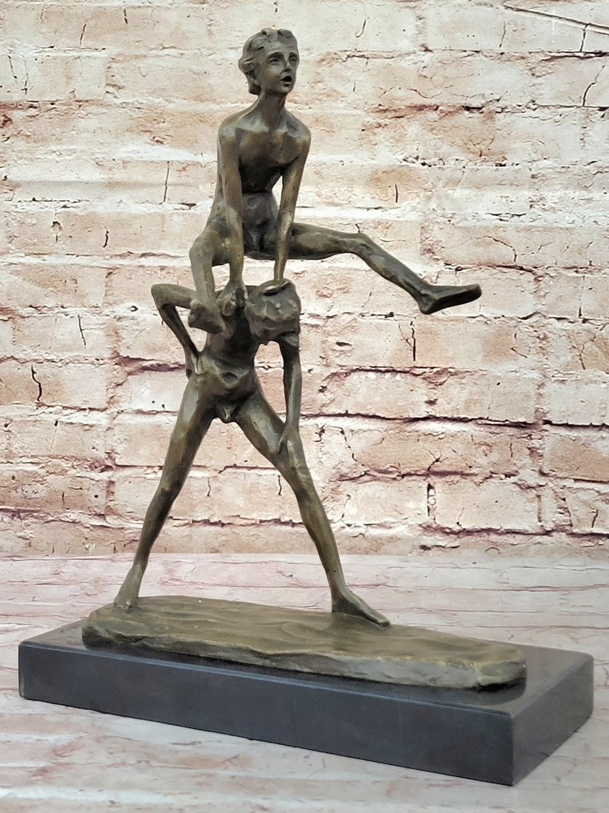 A bronze sculpture depicting two children playing leap-frog Home Decor Sale