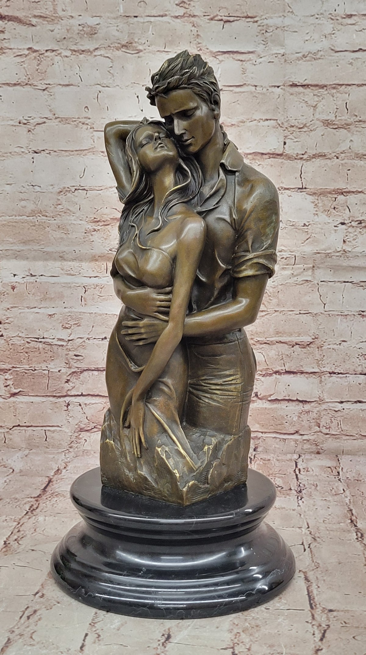 Bronze sculpture of a couple`s tender embrace portrays the power of intimacy