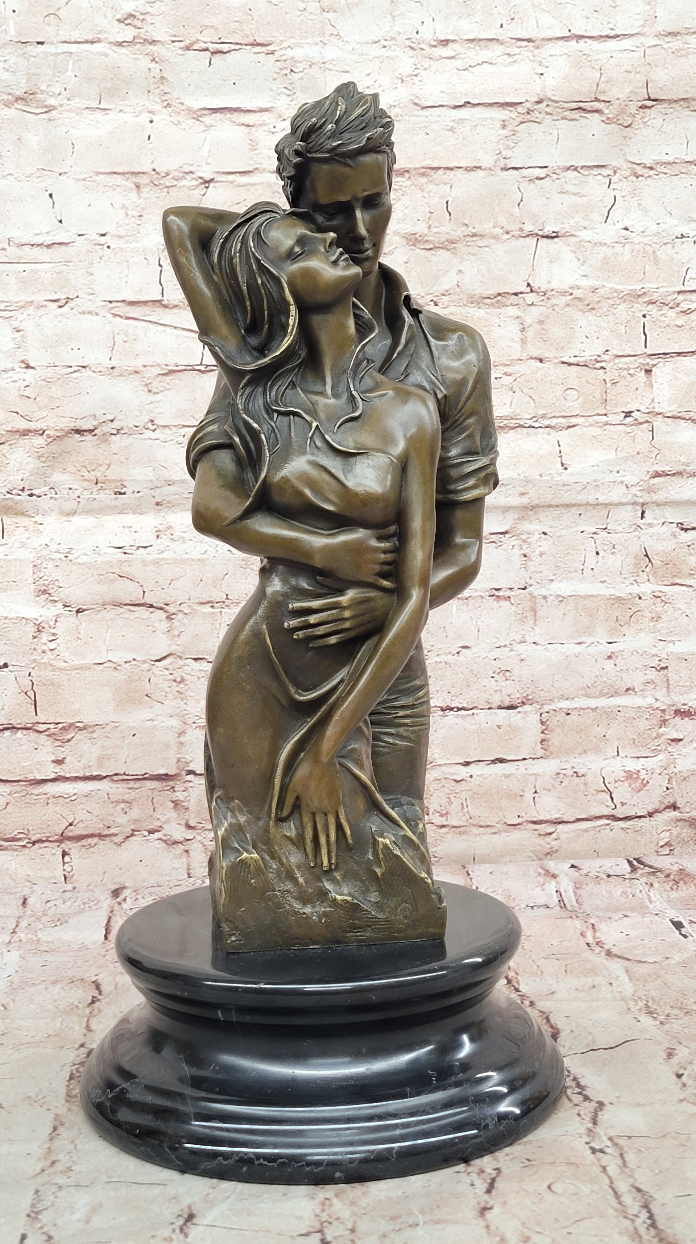 Bronze sculpture of a couple`s tender embrace portrays the power of intimacy