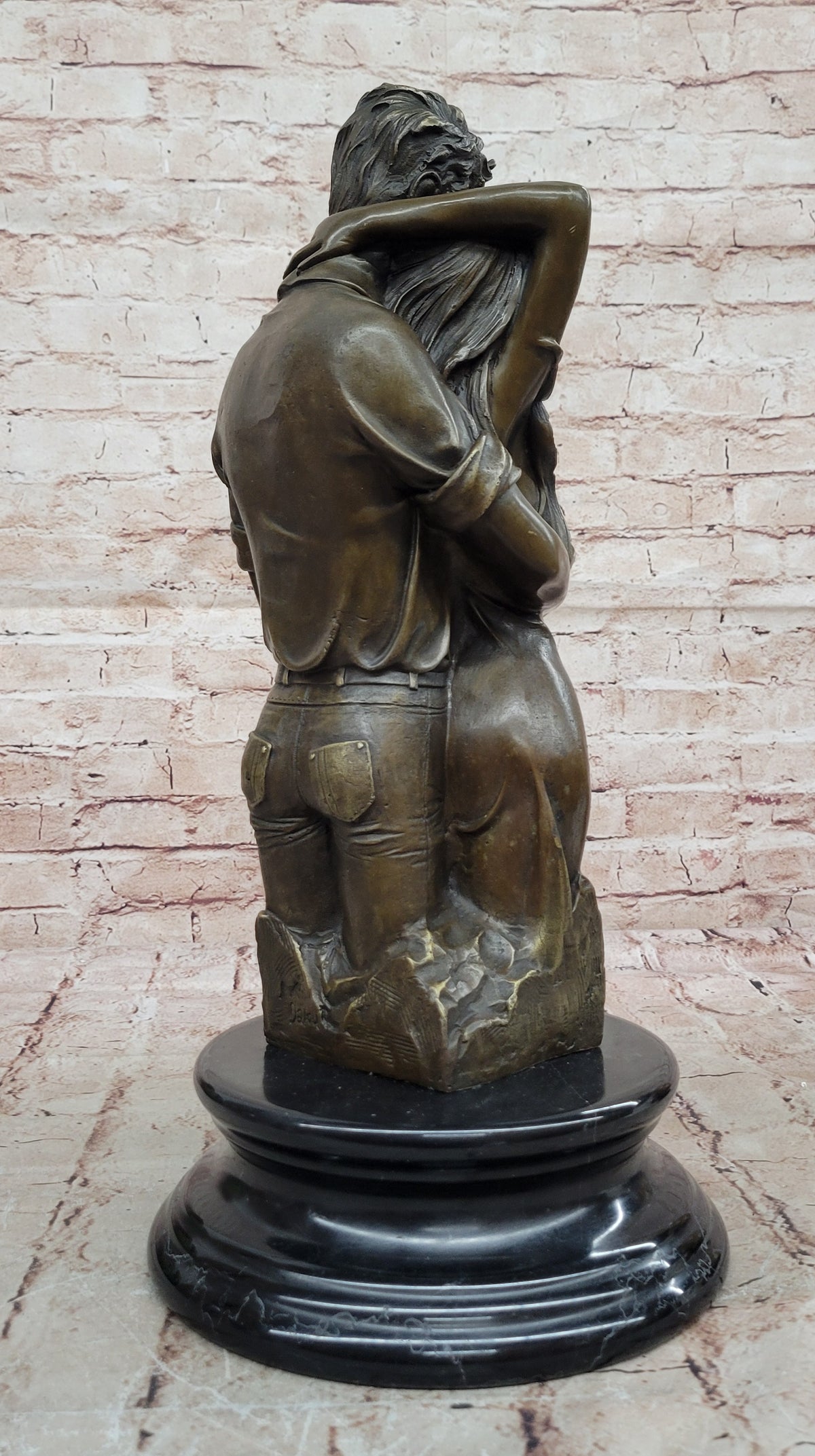 Bronze sculpture of a couple`s tender embrace portrays the power of intimacy