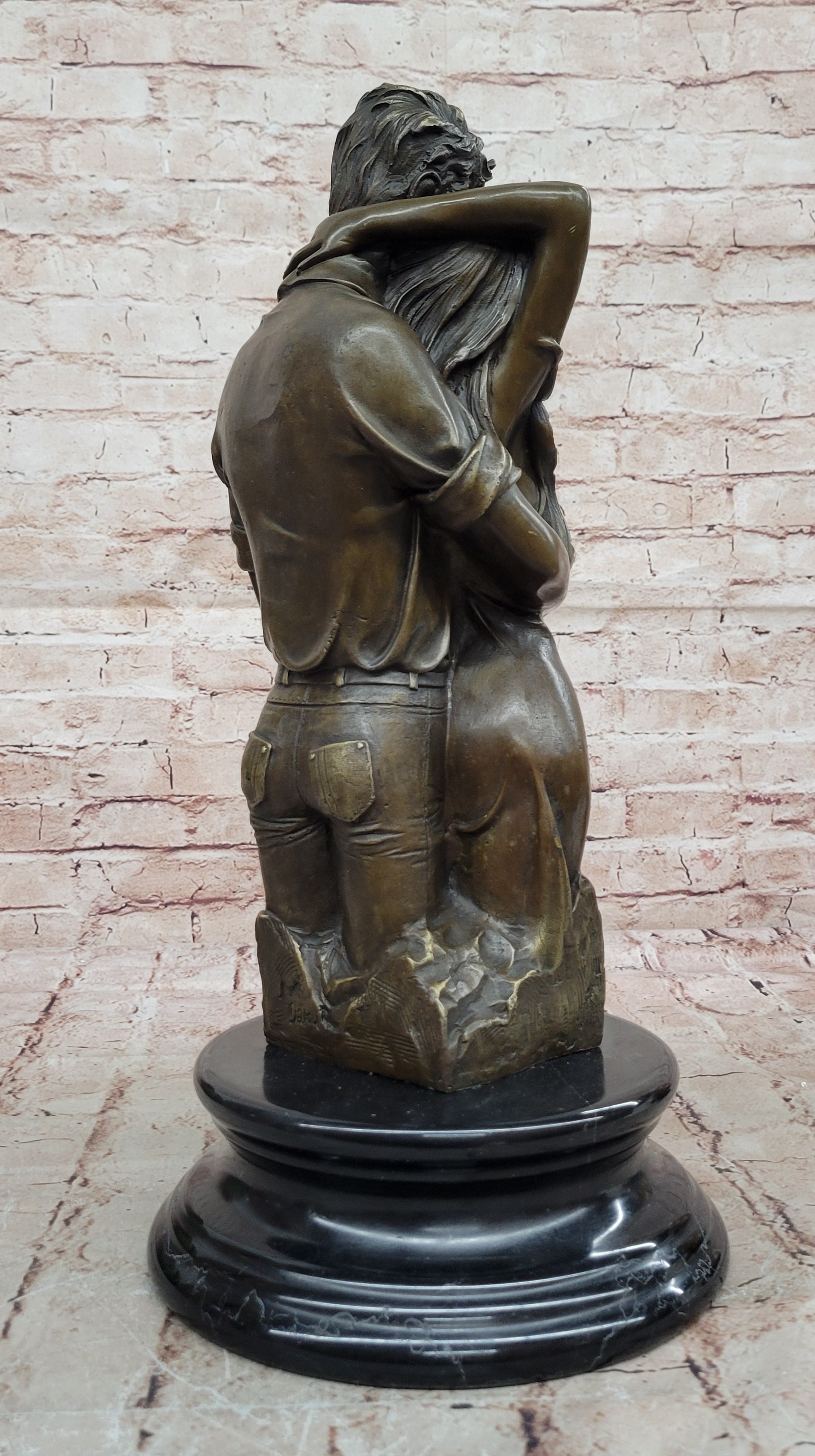 Bronze sculpture of a couple`s tender embrace portrays the power of intimacy