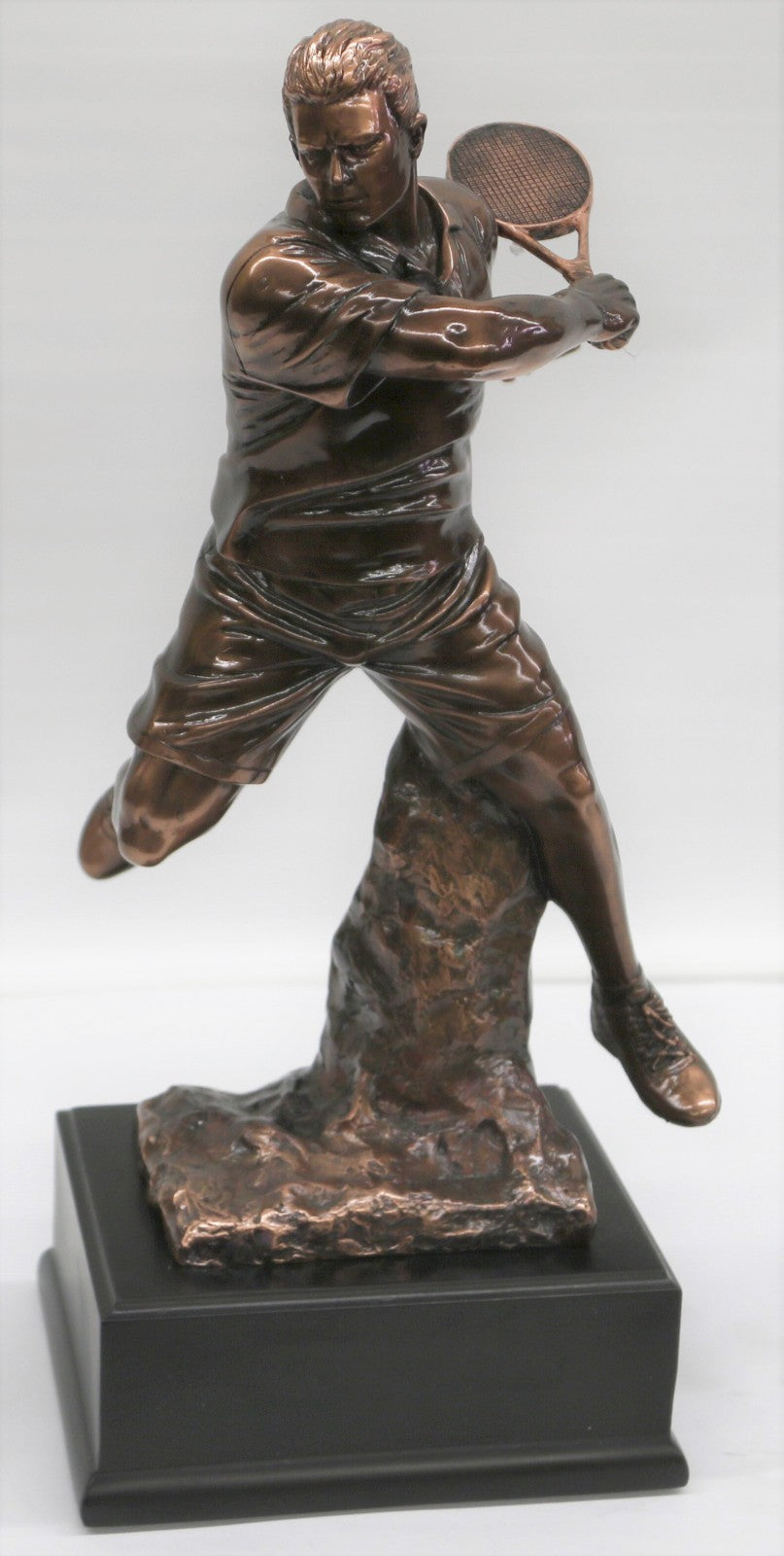 The Male Tennis player depicted wearing sporty gear and chunky Shoes