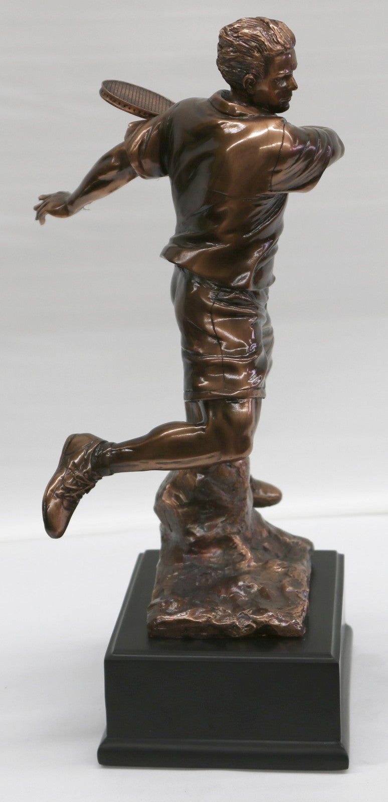 The Male Tennis player depicted wearing sporty gear and chunky Shoes