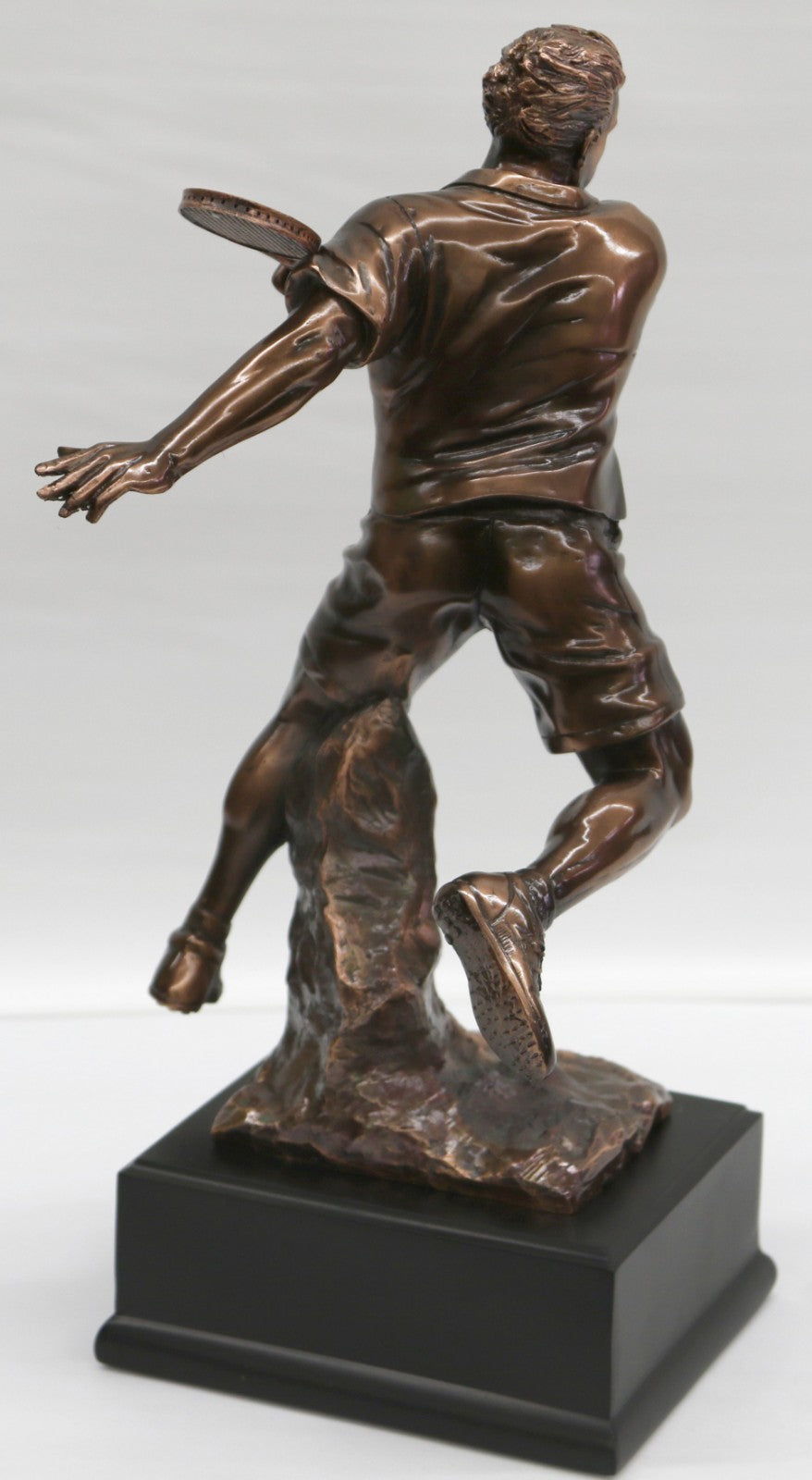 The Male Tennis player depicted wearing sporty gear and chunky Shoes