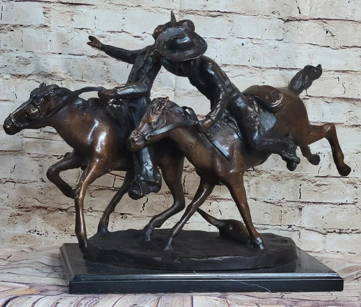 Horse and cowboy Western bronze sculpture, “Bunkie Wounded” by Remington