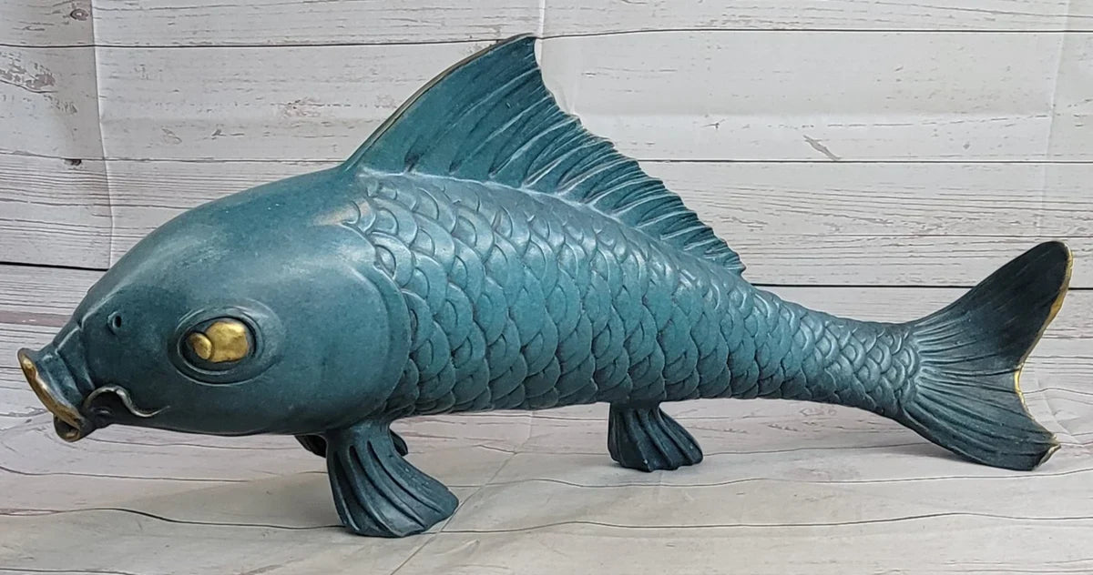 Teal bronze fish sculpture with gold accents, illustrating the desirable blue/green patina aging process.