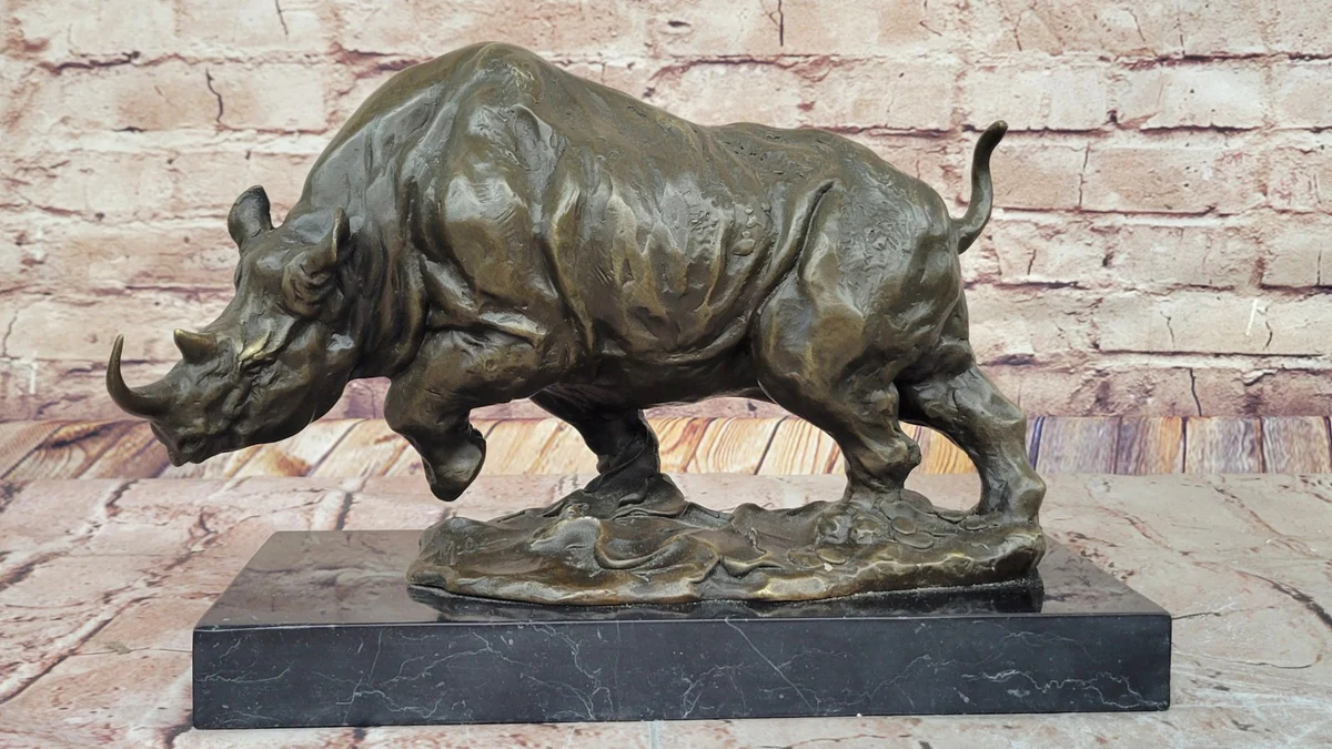 Powerful bronze rhino sculpture on a black marble base, adding cultural weight and boldness to a home.