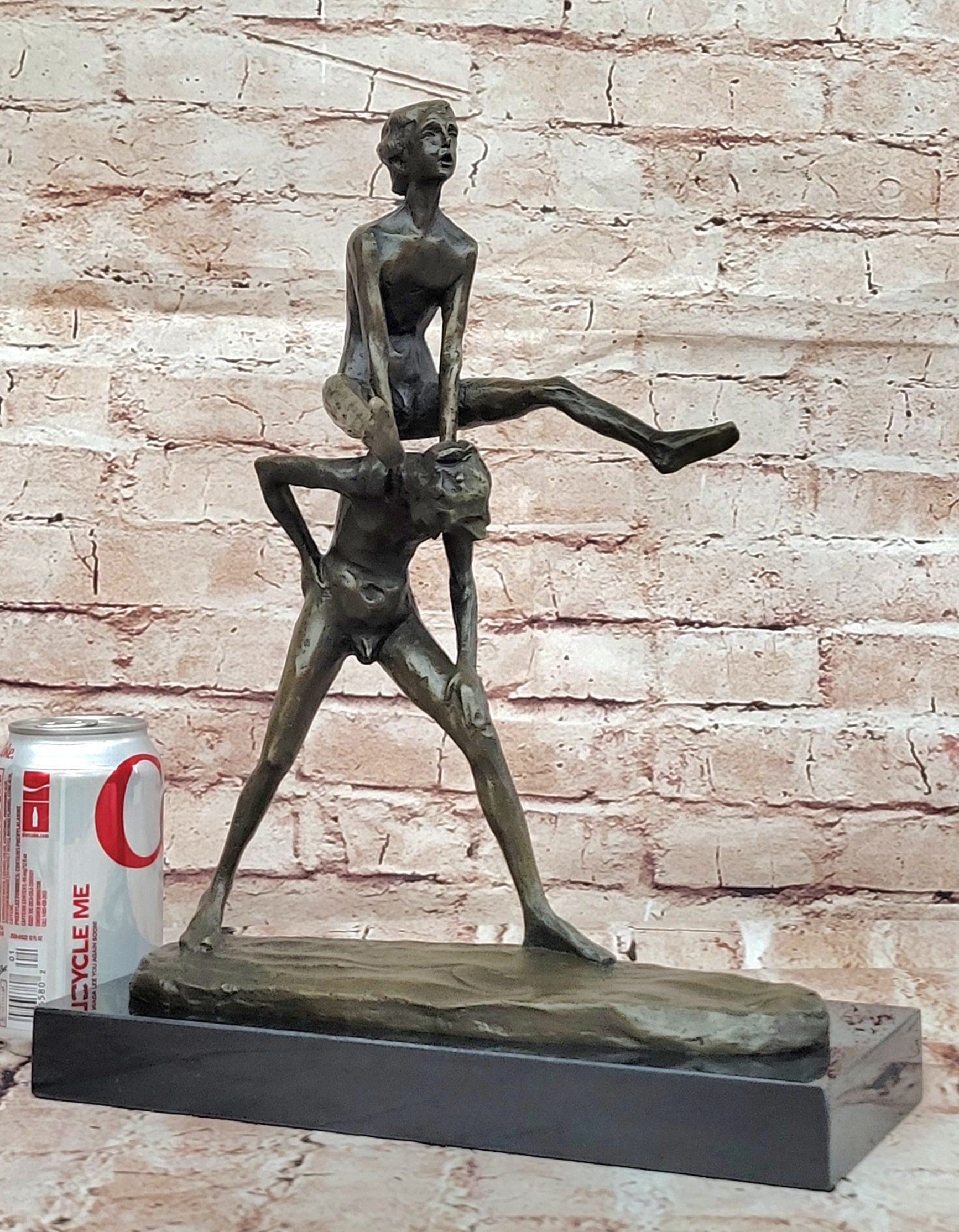 A bronze sculpture depicting two children playing leap-frog Home Decor Sale