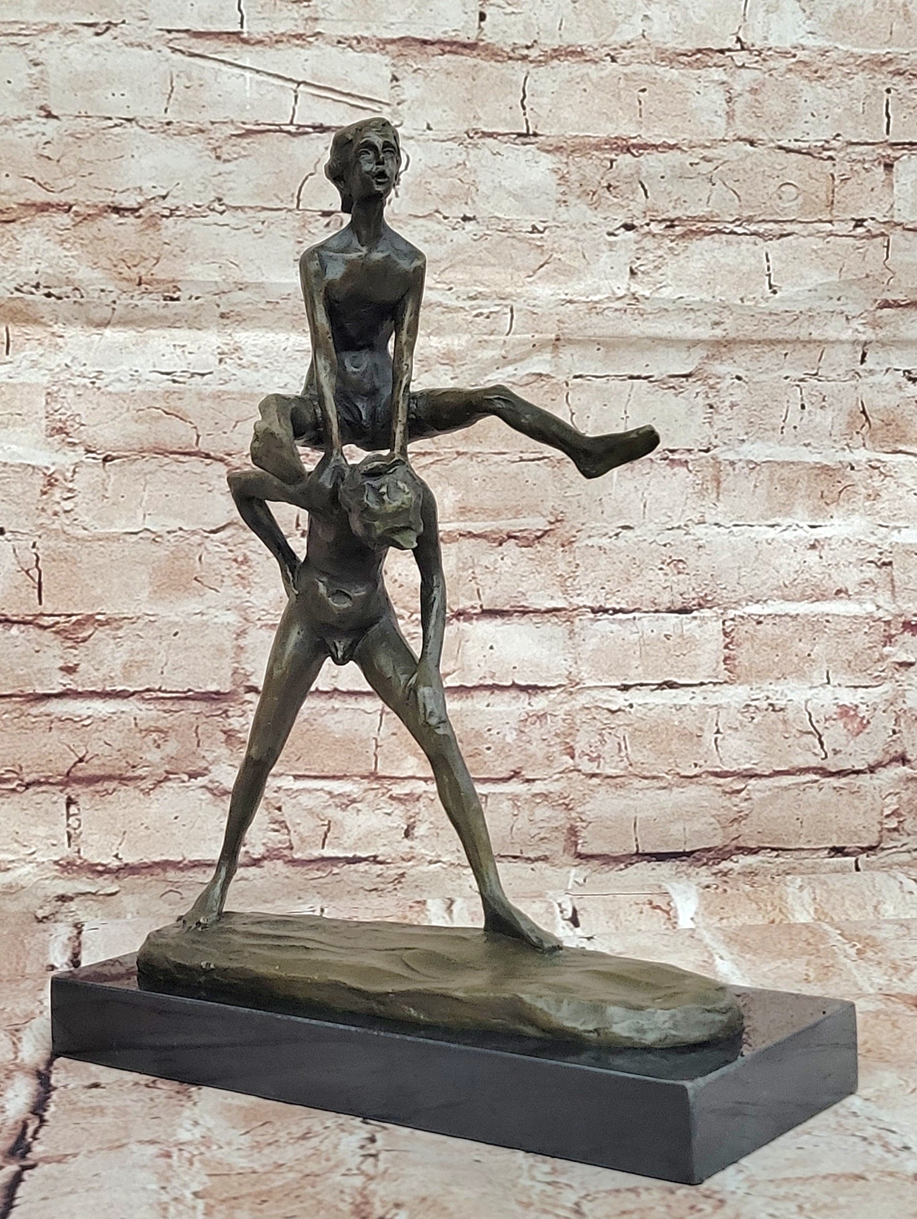 A bronze sculpture depicting two children playing leap-frog Home Decor Sale
