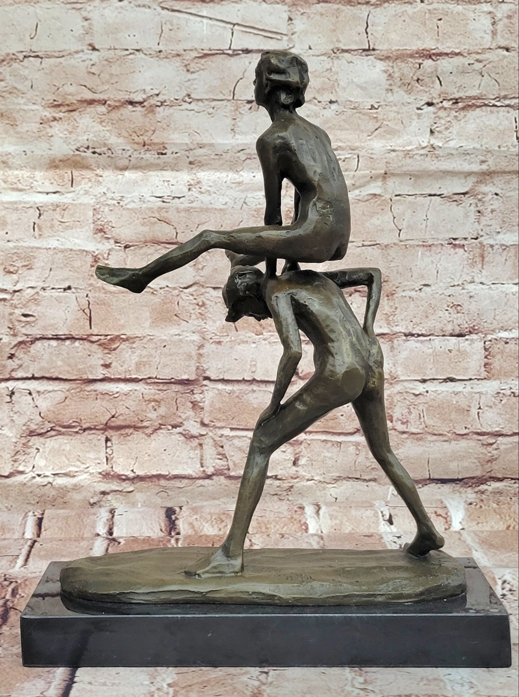 A bronze sculpture depicting two children playing leap-frog Home Decor Sale