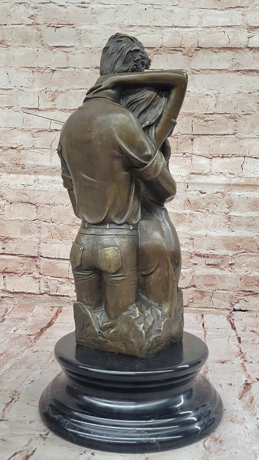 Bronze sculpture of a couple`s tender embrace portrays the power of intimacy