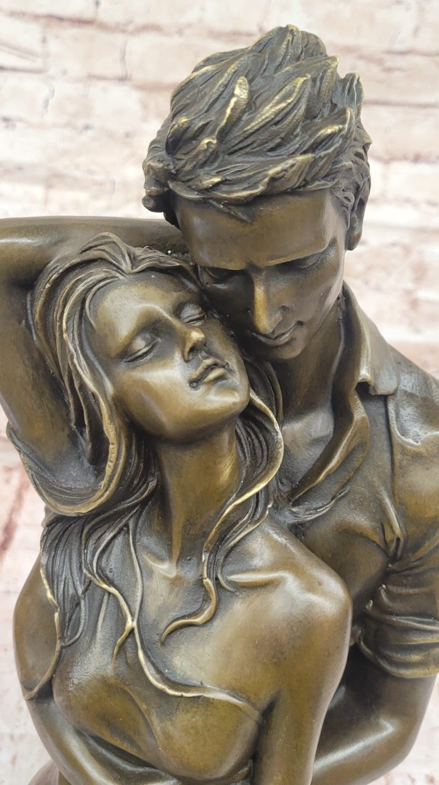 Bronze sculpture of a couple`s tender embrace portrays the power of intimacy