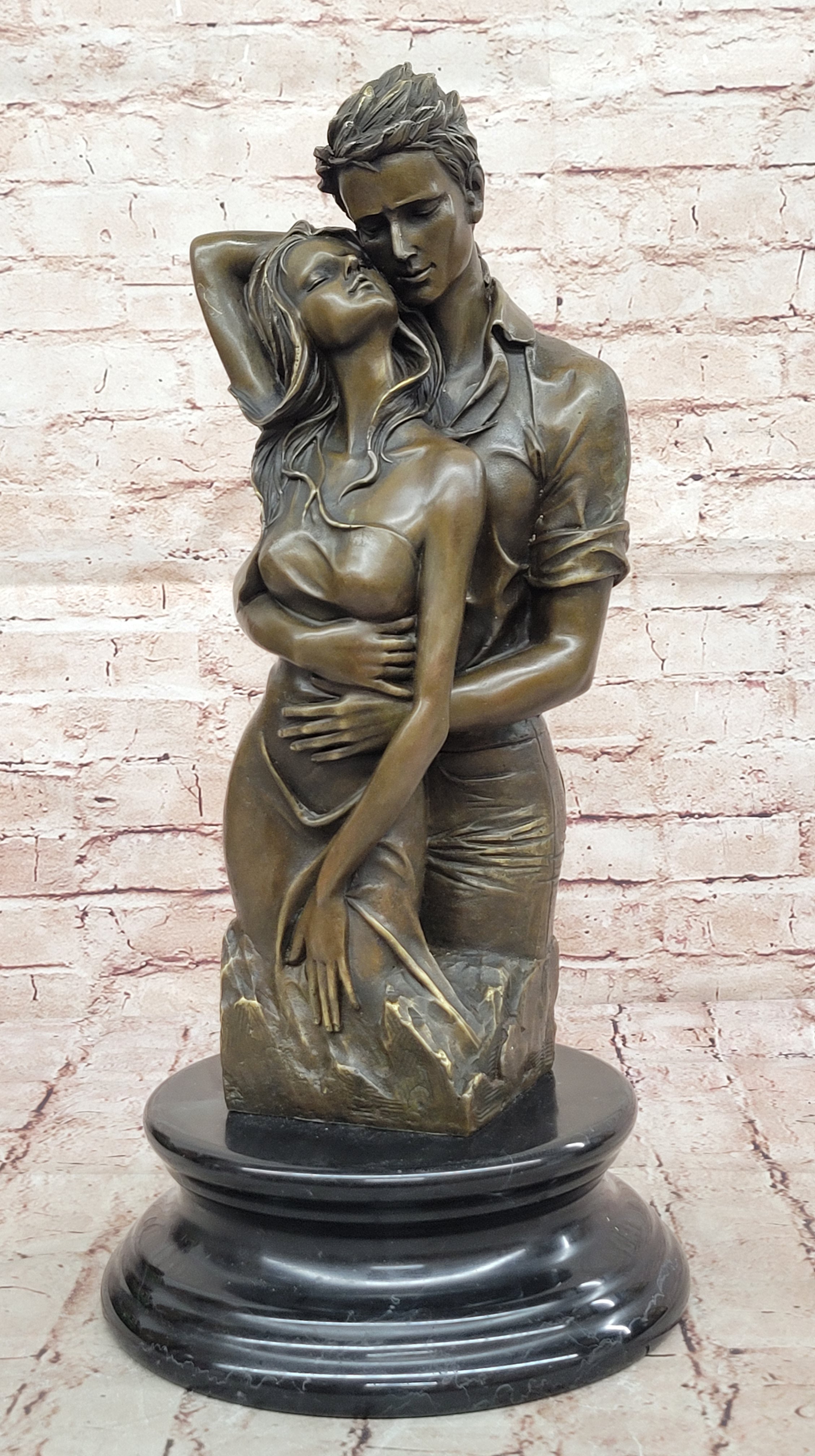 Bronze sculpture of a couple`s tender embrace portrays the power of intimacy