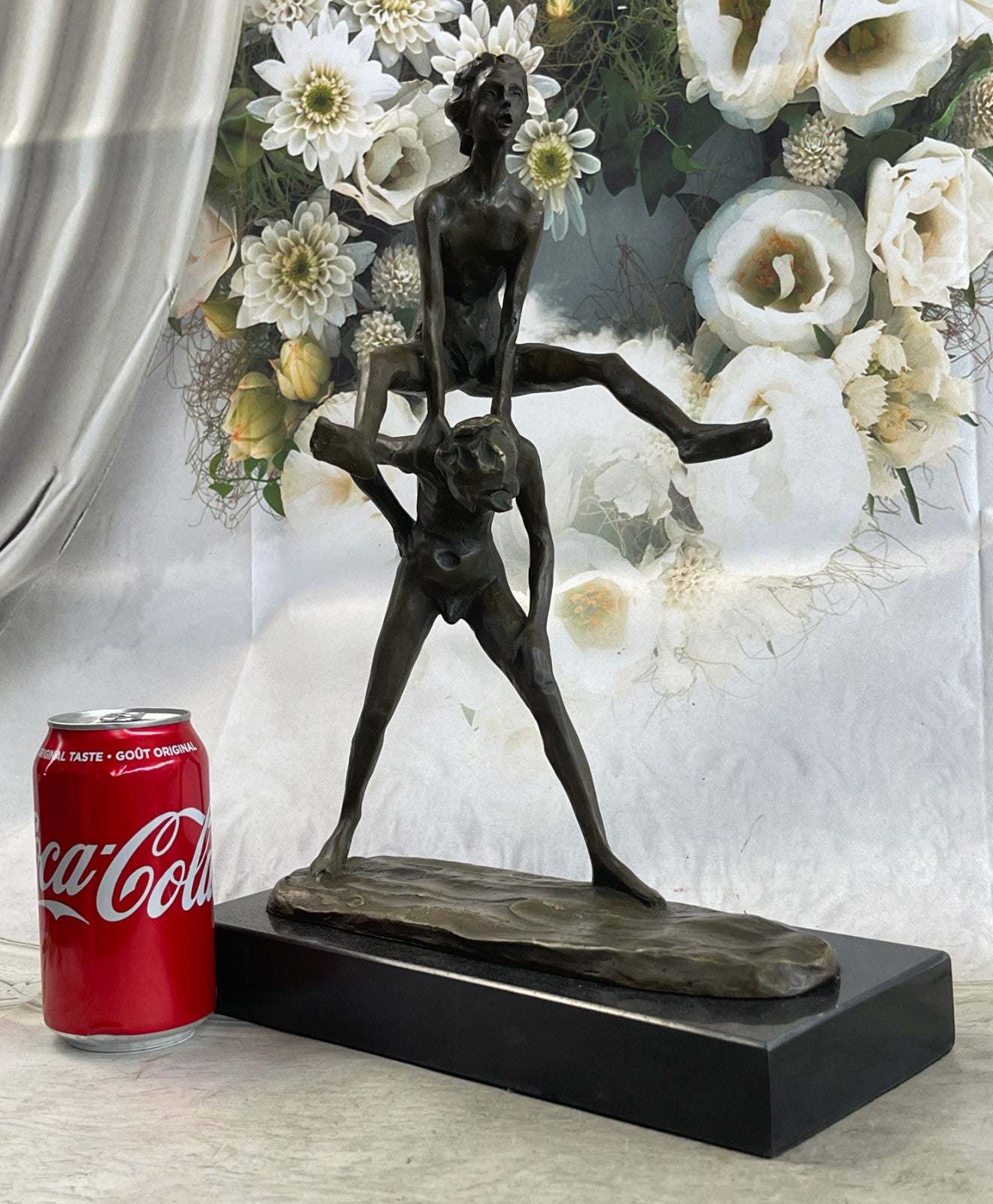 A bronze sculpture depicting two children playing leap-frog Home Decor Sale