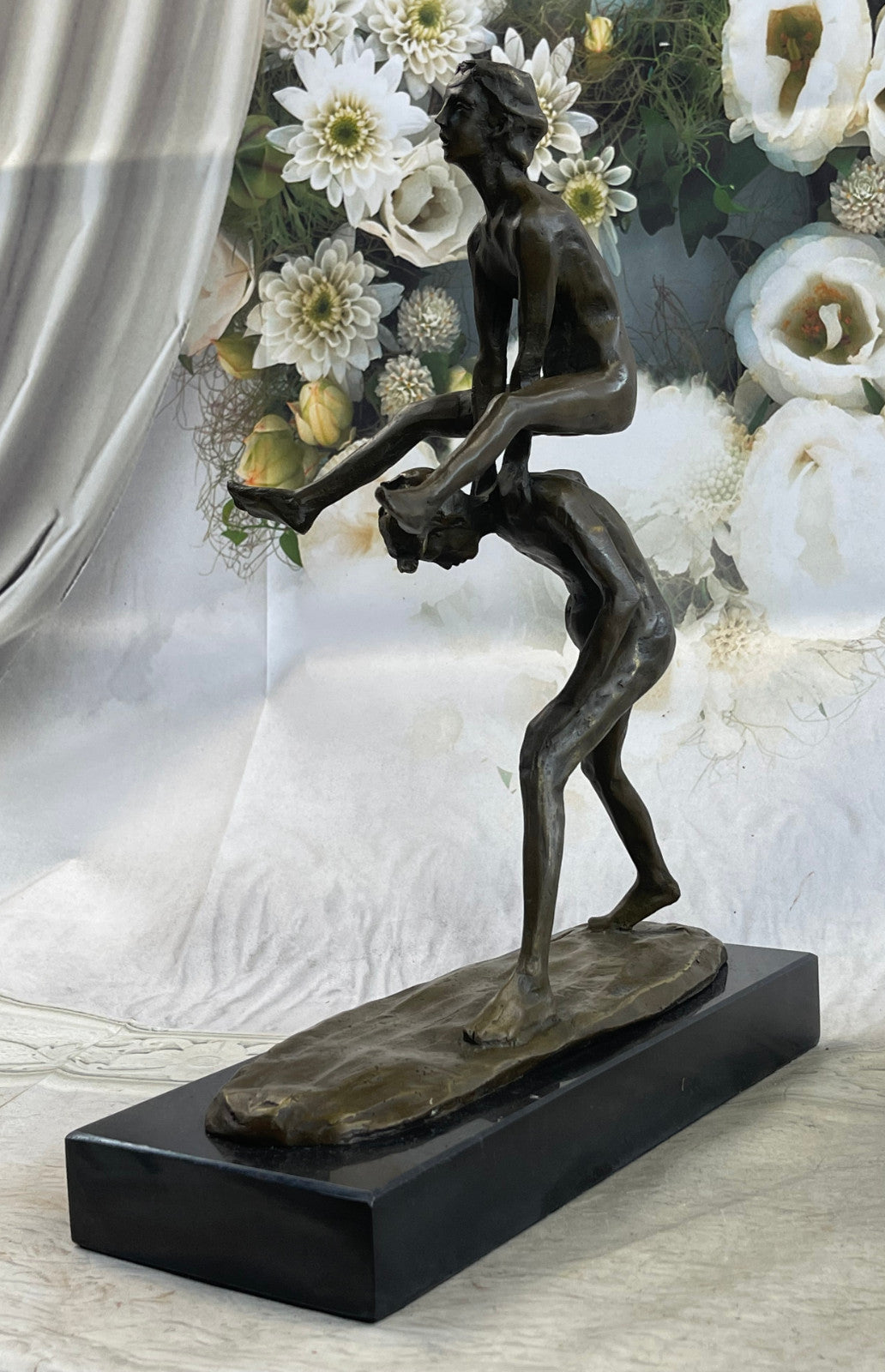 A bronze sculpture depicting two children playing leap-frog Home Decor Sale