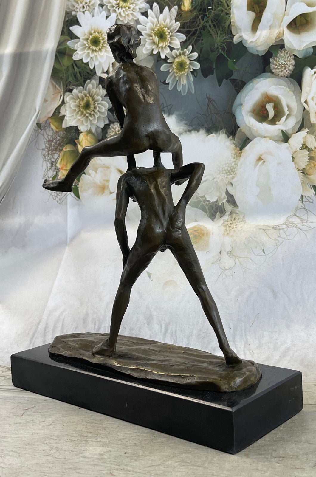 A bronze sculpture depicting two children playing leap-frog Home Decor Sale