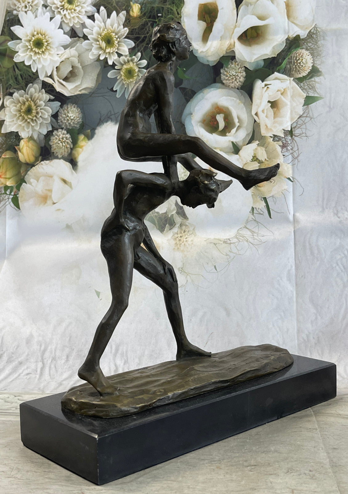 A bronze sculpture depicting two children playing leap-frog Home Decor Sale