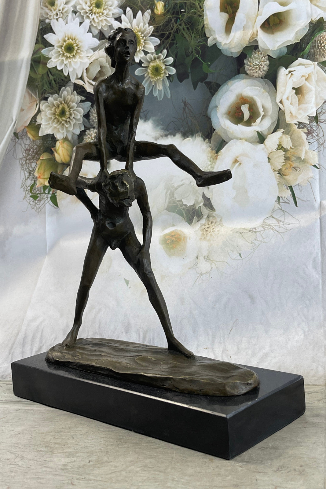A bronze sculpture depicting two children playing leap-frog Home Decor Sale