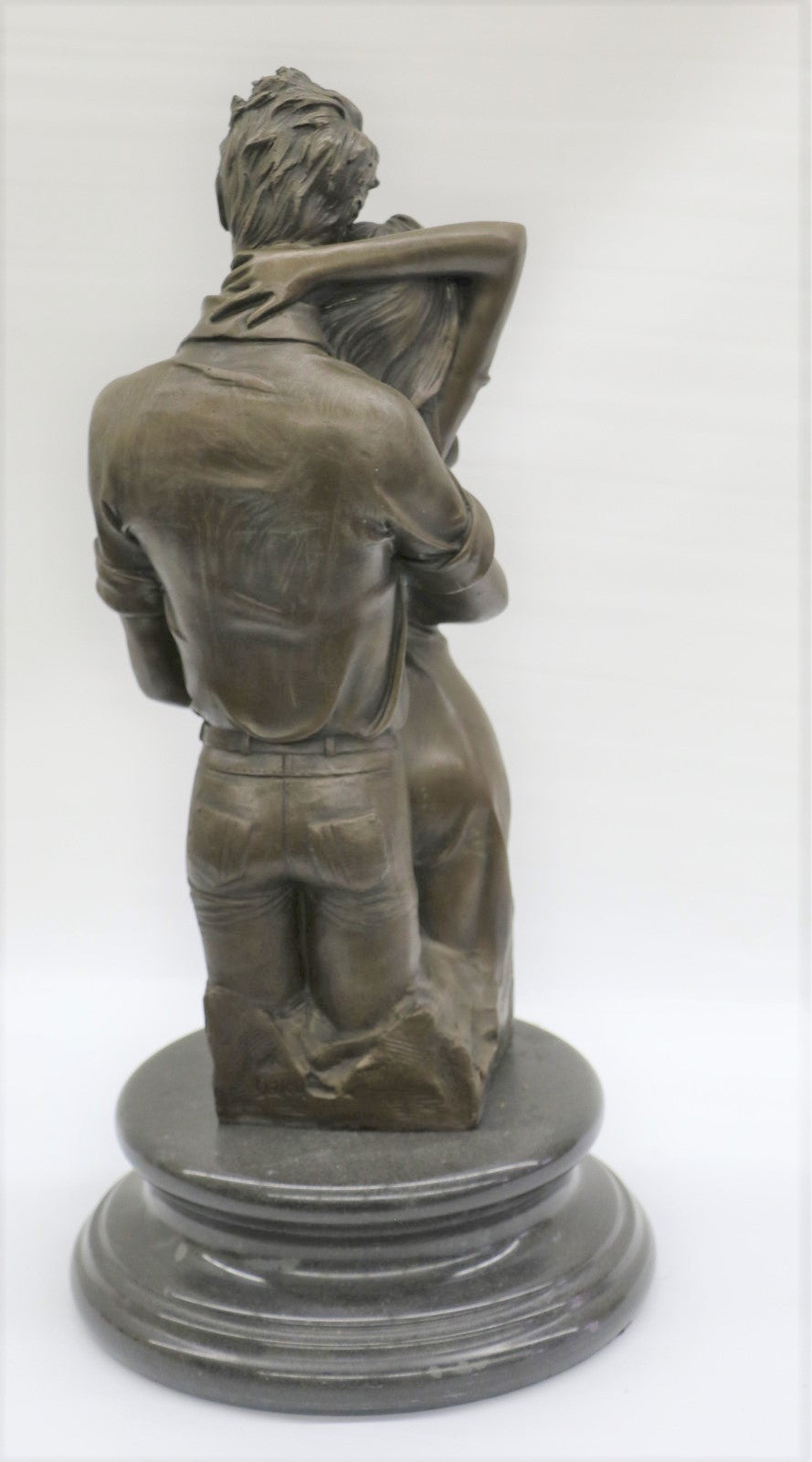 Bronze sculpture of a couple's tender embrace portrays the power of intimacy